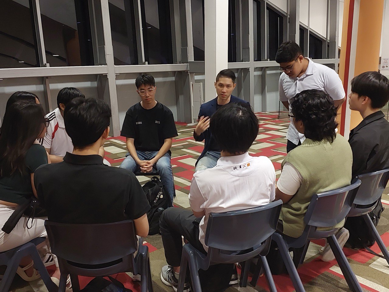 Brandon mentoring youth in a circle discussion
